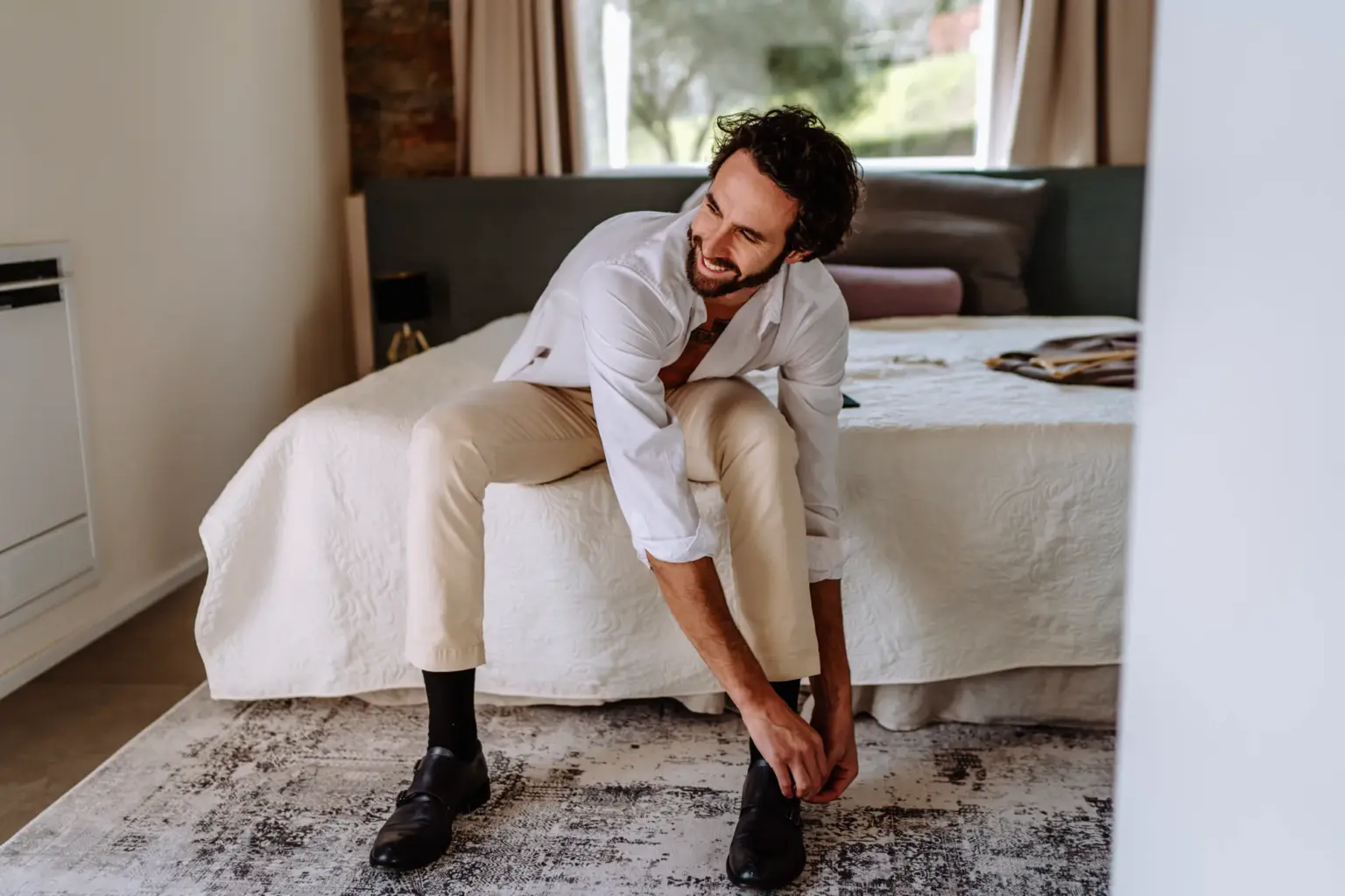 Bräutigam zieht sich die Schuhe beim Getting Ready an